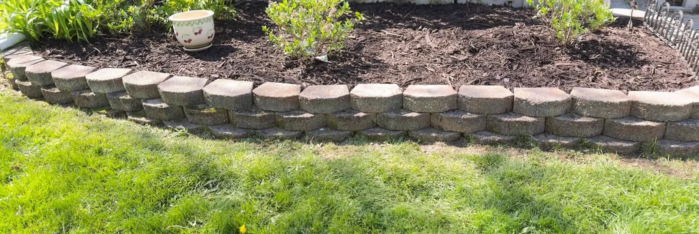 Fresh mulch and a tidy stone-edged garden bed in Ann Arbor, Michigan